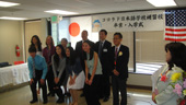 Commemorative photograph of honored graduates and officials.